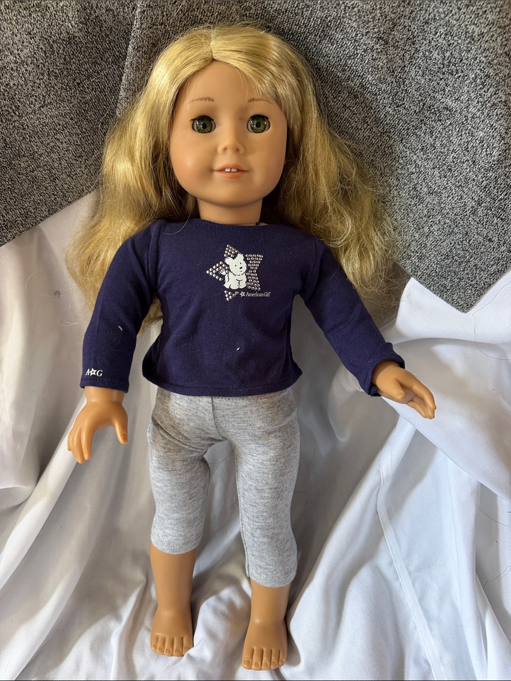 American Girl Blonde Doll in Navy Top and Light Gray Capri Leggings.
